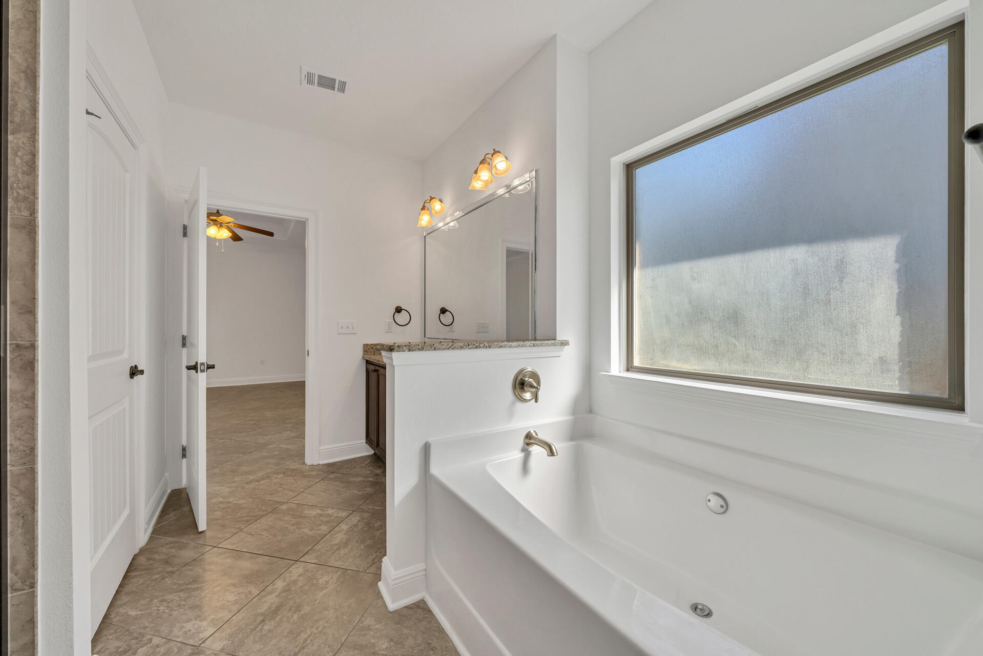 137 Lullaby Loop Santa Rosa Beach, FL 32459 - Photo 25 of 33 a bathroom with a tub a sink and a mirror