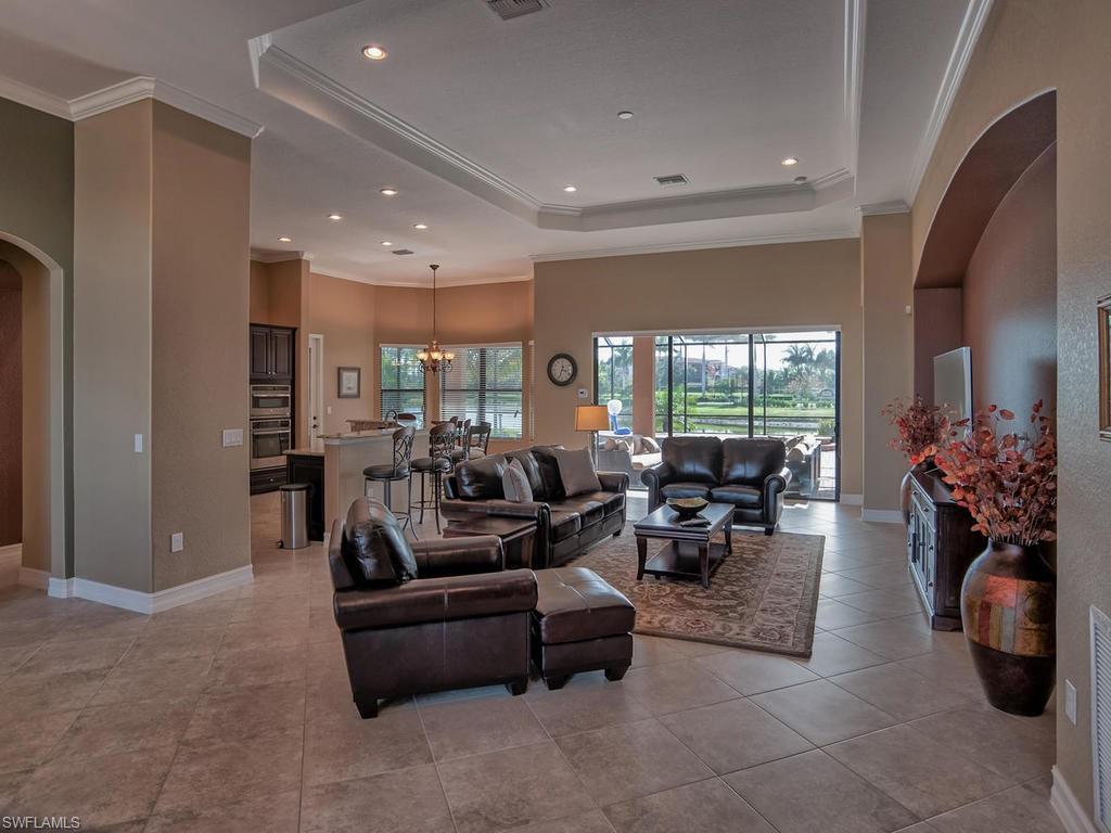9634 Firenze Circle Naples, FL 34113 - Photo 3 of 35 a living room with fireplace furniture and a large window