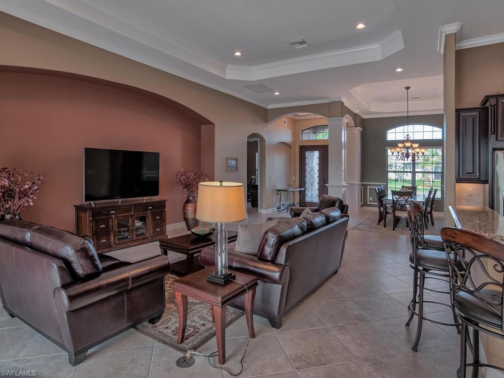 9634 Firenze Circle Naples, FL 34113 - Photo 4 of 35 a living room with furniture and a flat screen tv