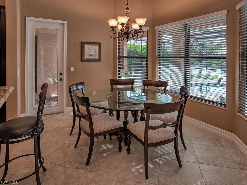 9634 Firenze Circle Naples, FL 34113 - Photo 8 of 35 a dining room with furniture and window