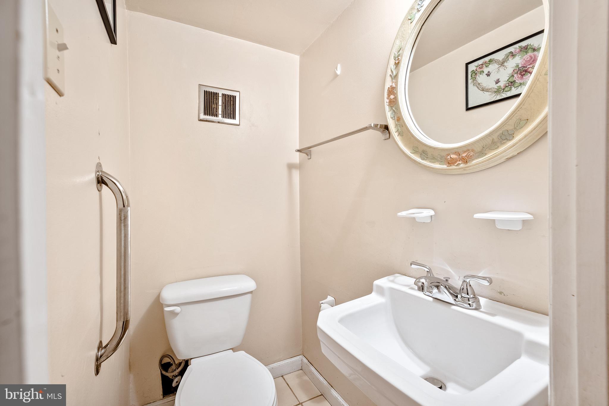 3464 Fitler Street Philadelphia, PA 19114 - Photo 13 of 22 a bathroom with a toilet sink and mirror