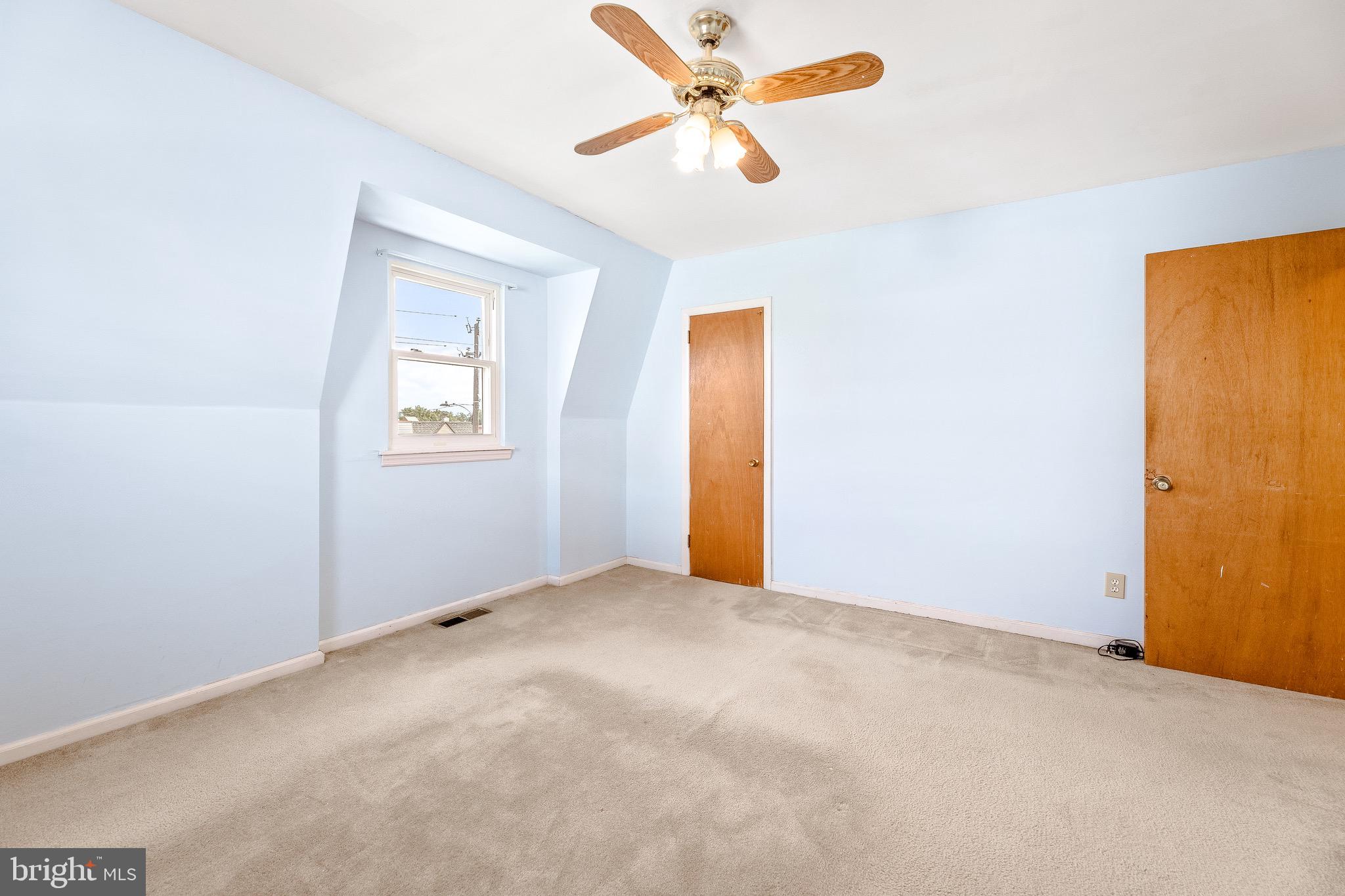 3464 Fitler Street Philadelphia, PA 19114 - Photo 15 of 22 an empty room with a ceiling fan and a window