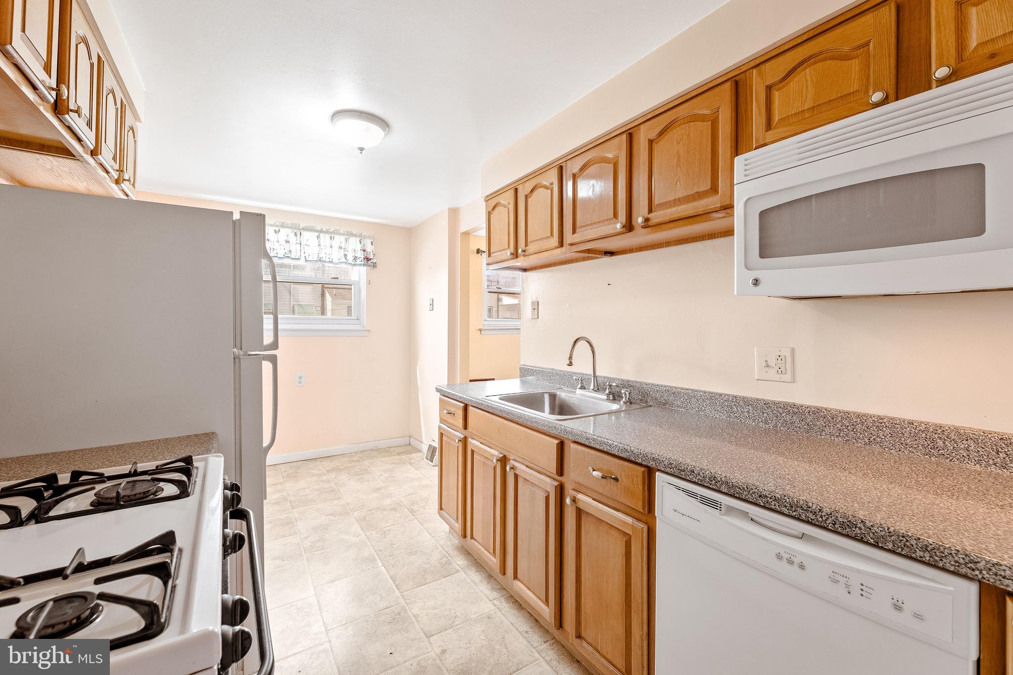 3464 Fitler Street Philadelphia, PA 19114 - Photo 8 of 22 a kitchen with stainless steel appliances granite countertop a sink stove and cabinets