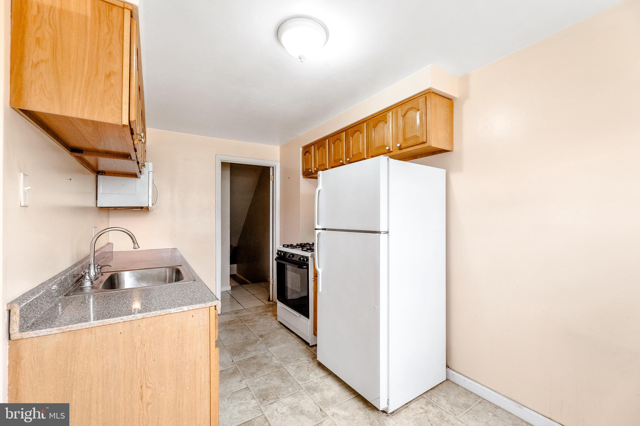 3464 Fitler Street Philadelphia, PA 19114 - Photo 9 of 22 a kitchen with a refrigerator and a sink