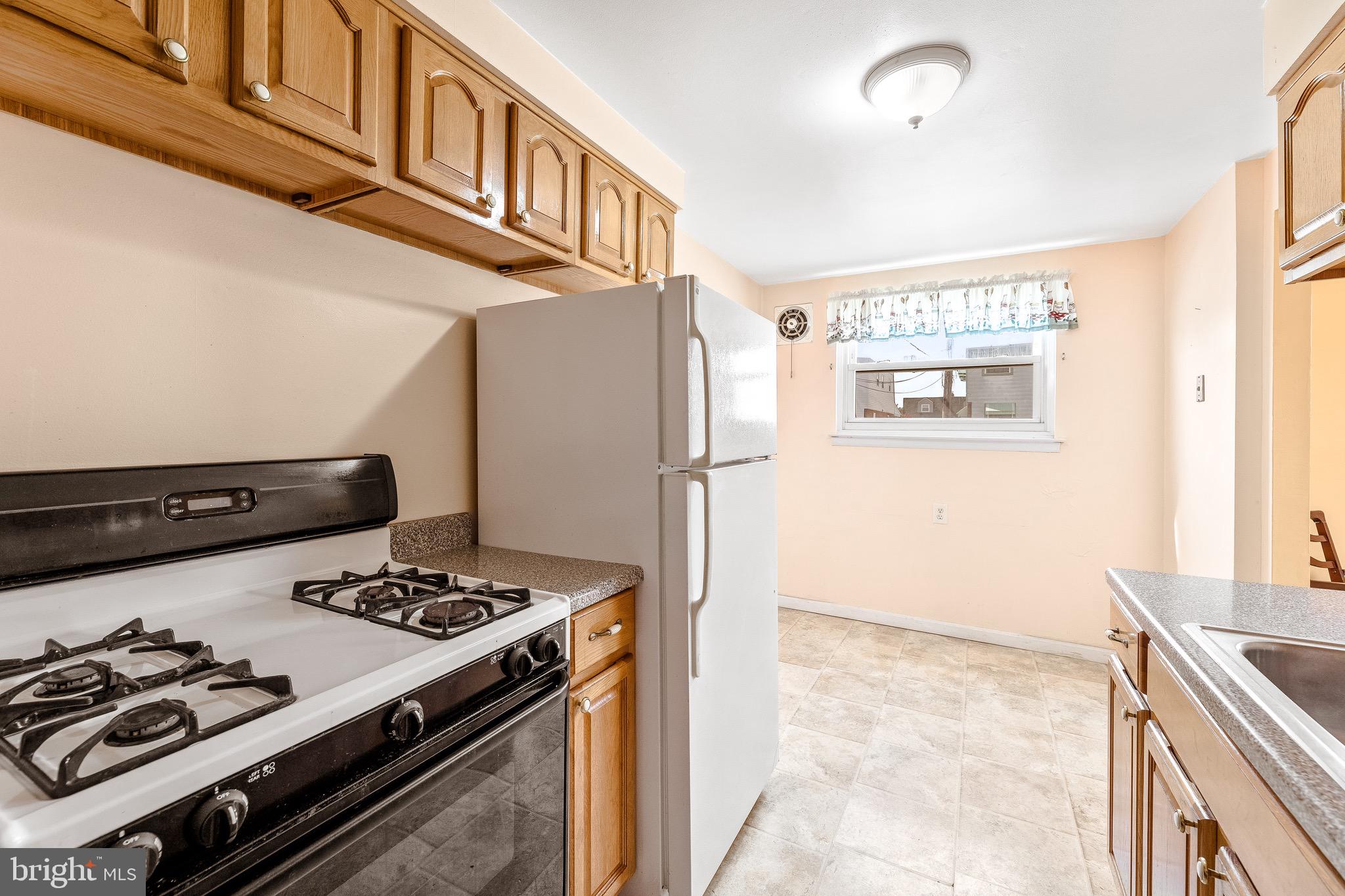 3464 Fitler Street Philadelphia, PA 19114 - Photo 10 of 22 a kitchen with stainless steel appliances granite countertop a stove and a refrigerator