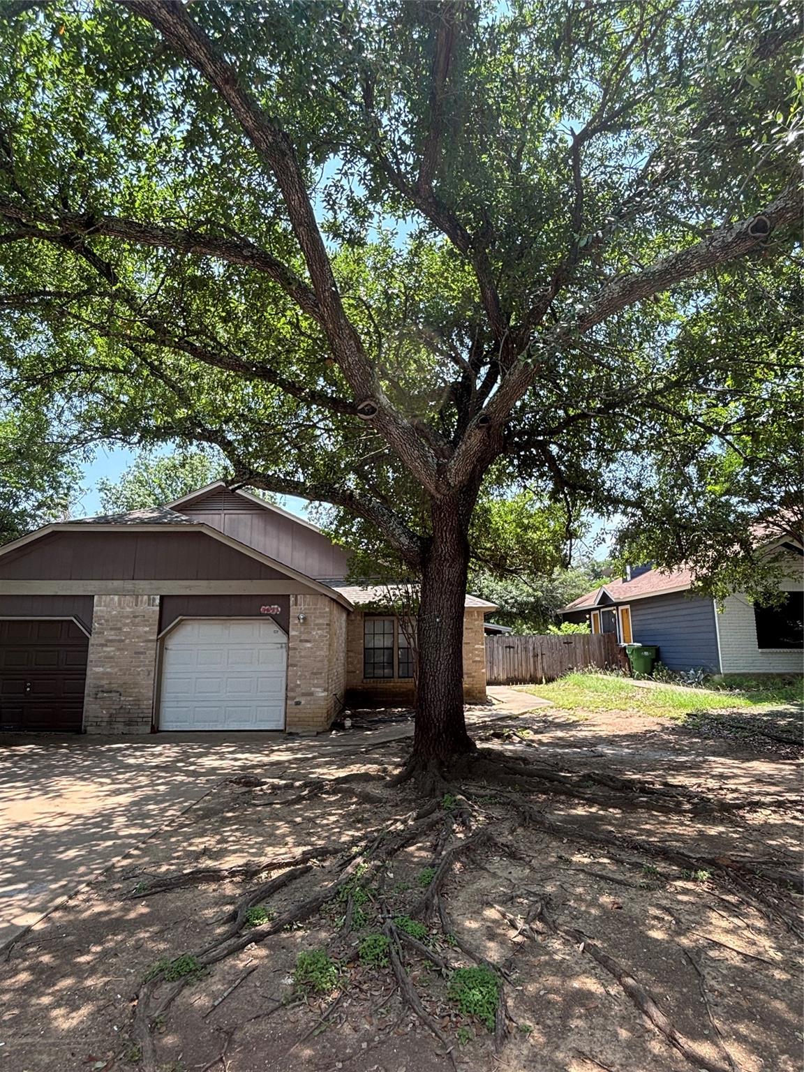 2033 Redwing Way Round Rock, TX 78664 - Photo 1 of 13 Mature tree canopy providing shade to the front yard