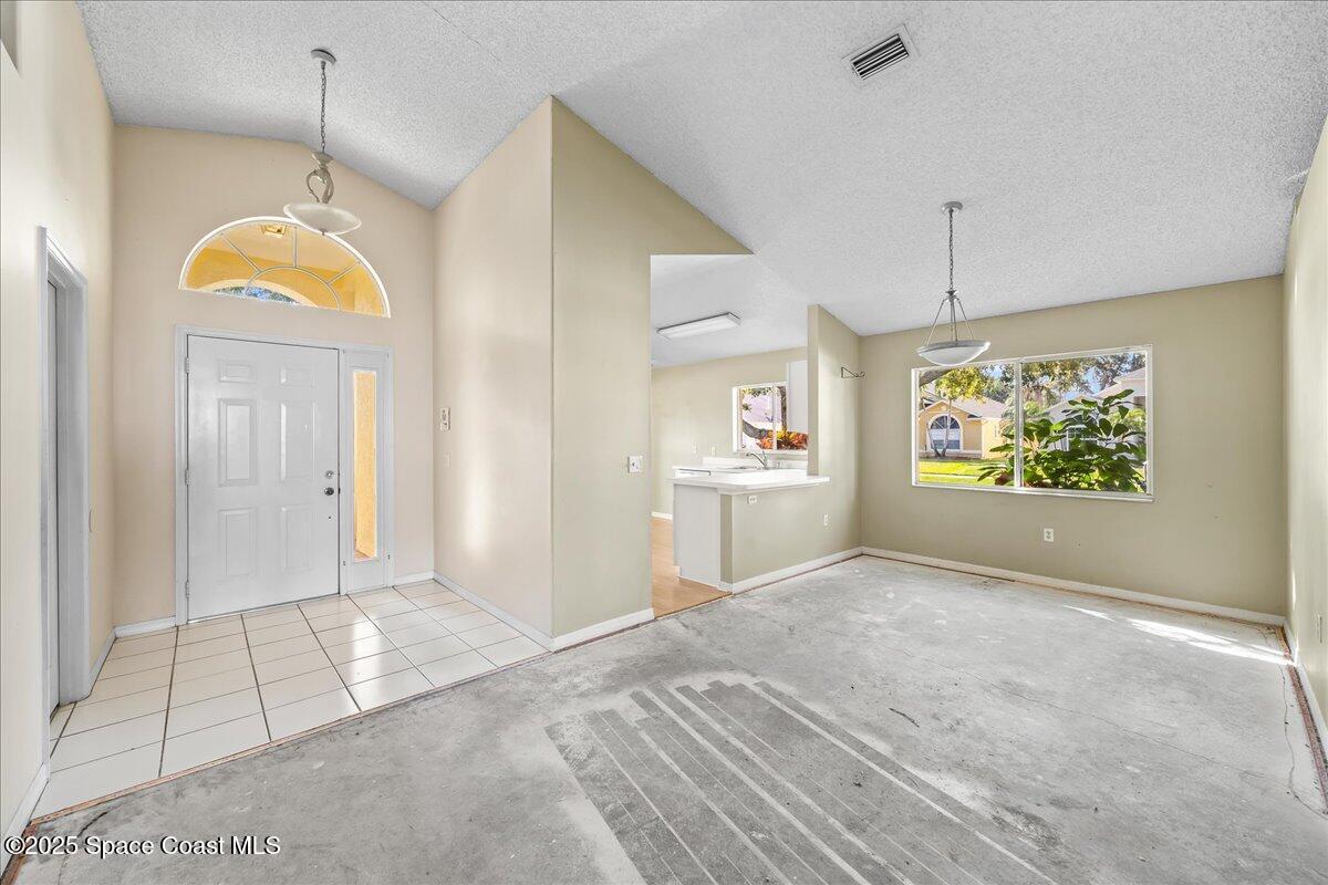 2798 Caitlin Court Melbourne, FL 32940 - Photo 17 of 27 a view of an empty room with window and cabinet
