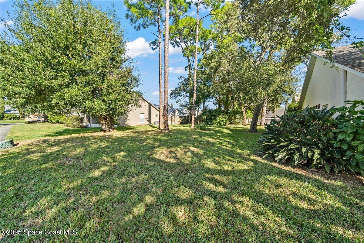 2798 Caitlin Court Melbourne, FL 32940 - Photo 26 of 27 a big yard with lots of green space and plants