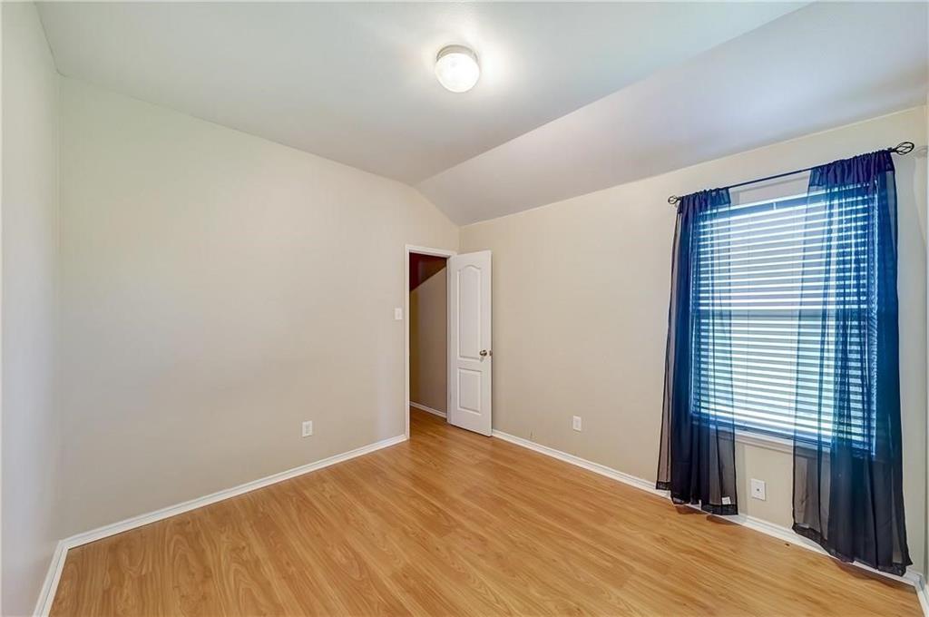 1404 Trading Post Drive Fort Worth, TX 76131 - Photo 19 of 25 an empty room with wooden floor and windows