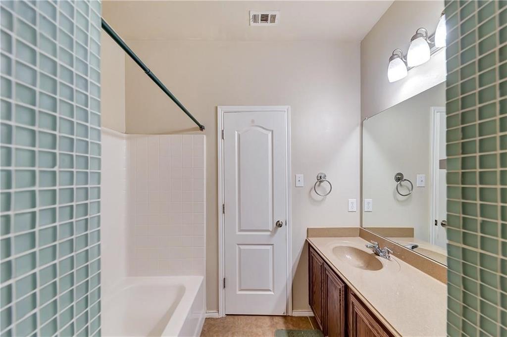 1404 Trading Post Drive Fort Worth, TX 76131 - Photo 21 of 25 a bathroom with a granite countertop sink a toilet and shower
