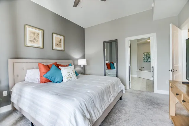 a bedroom with a large bed and a chandelier