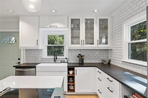 a kitchen that has a sink and a stove in it