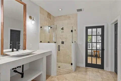 a bathroom with a shower sink and mirror