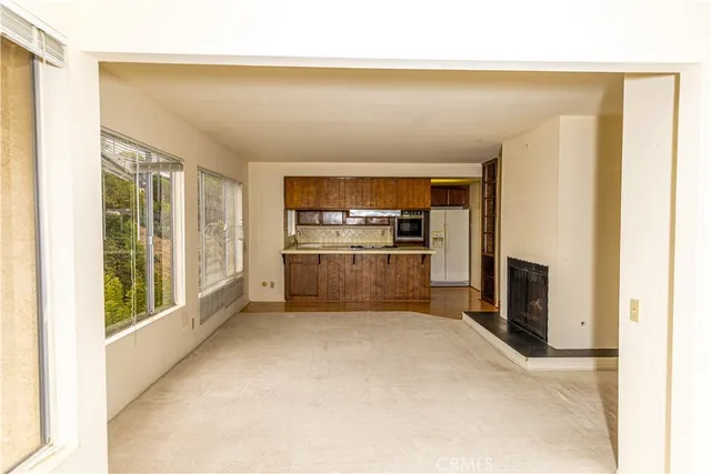 a kitchen with white cabinets and a refrigerator