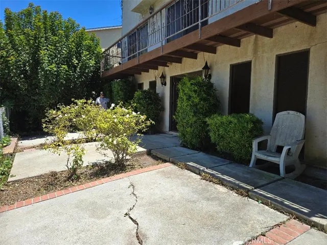 a backyard of a house with a yard and outdoor seating