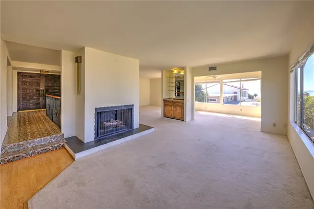 an empty room with furniture and a fireplace
