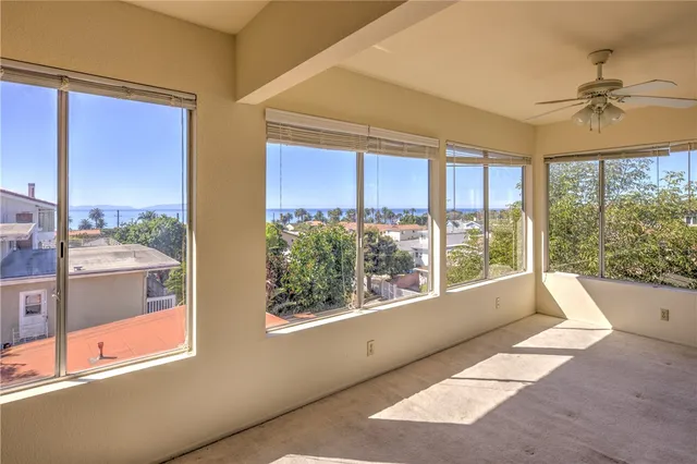 a living room filled with furniture and a window