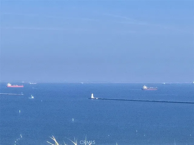 a view of a white building with couches in front of it
