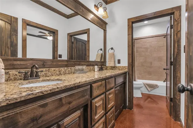 a spacious bedroom with a bed and a chandelier