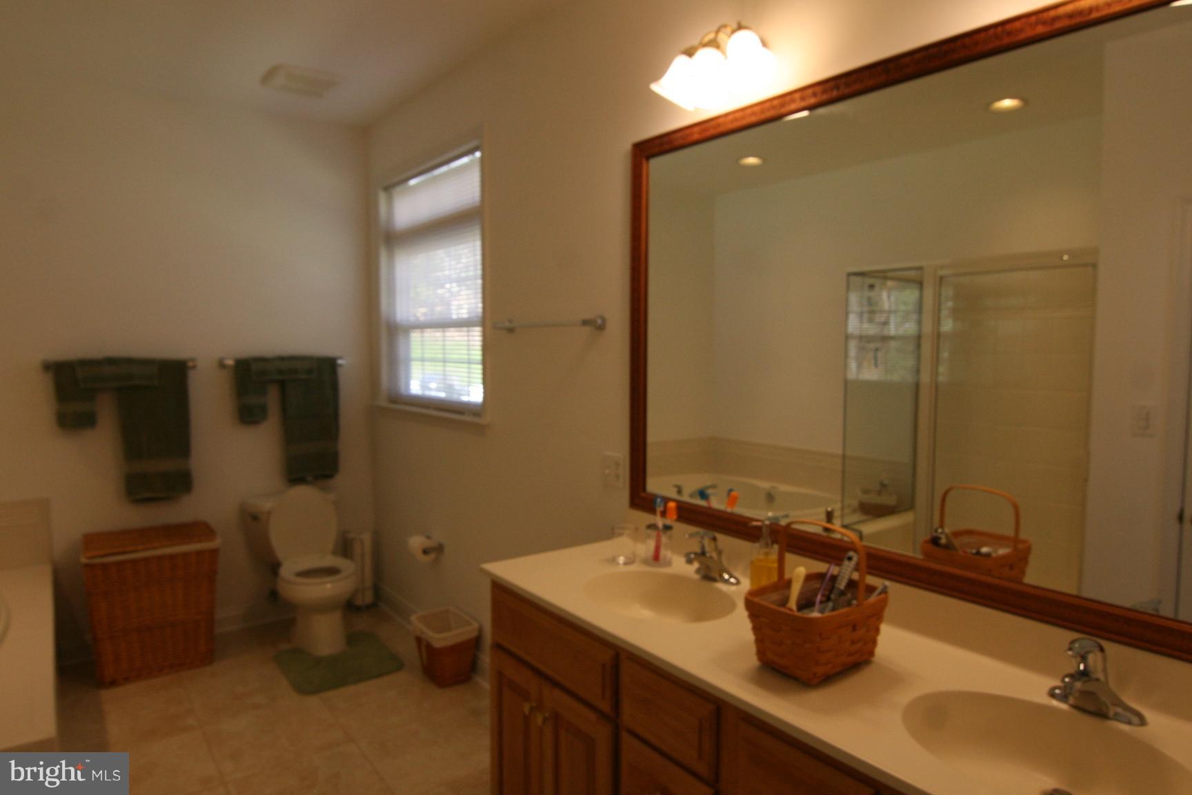 3535 Yellow Bank Road Dunkirk, MD 20754 - Photo 20 of 25 a bathroom with a granite countertop sink toilet and mirror