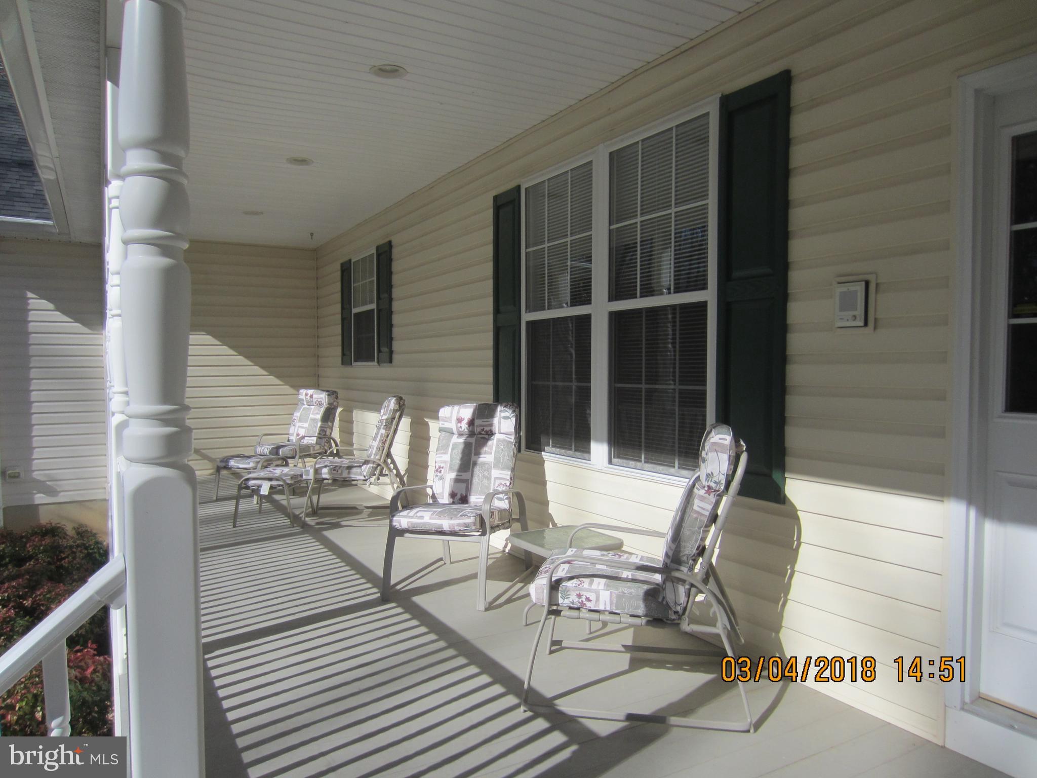 3535 Yellow Bank Road Dunkirk, MD 20754 - Photo 3 of 25 a view of a patio with table and chairs with wooden floor and fence