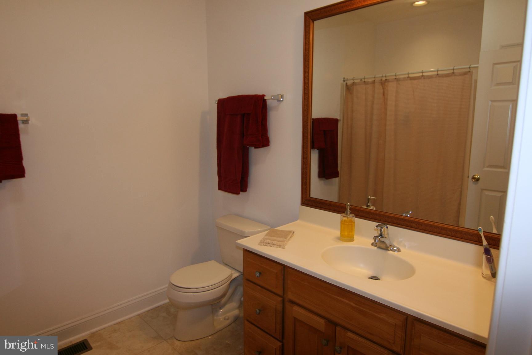 3535 Yellow Bank Road Dunkirk, MD 20754 - Photo 21 of 25 a bathroom with a sink vanity mirror and toilet