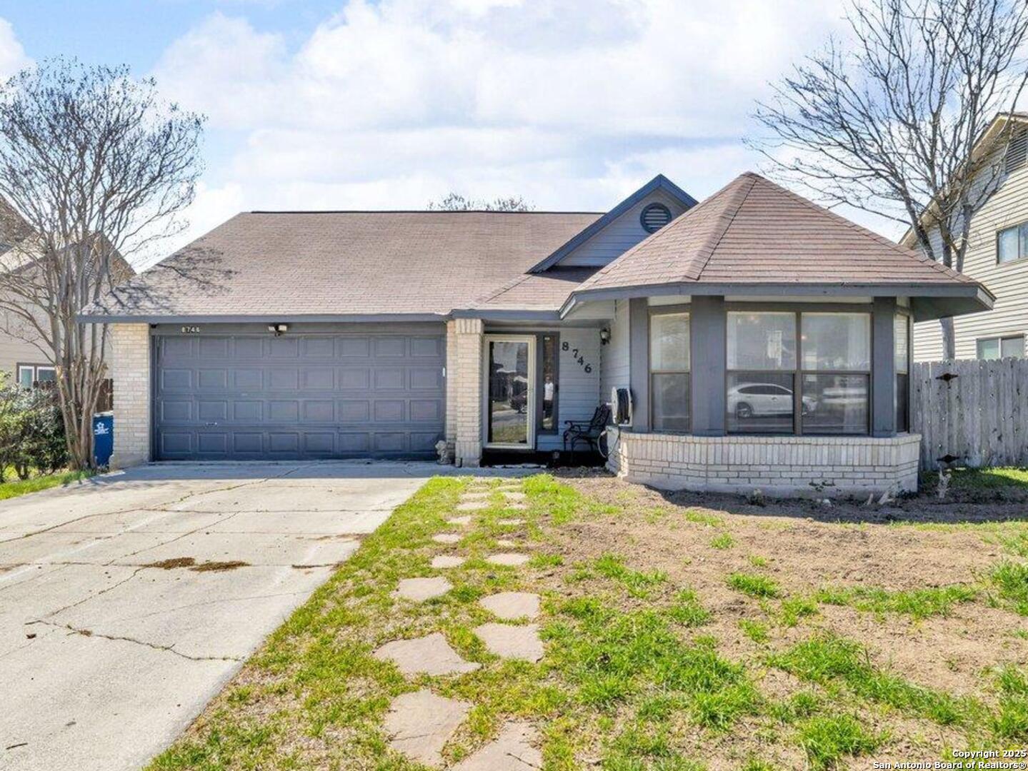 a view of house with yard and tree in front of it