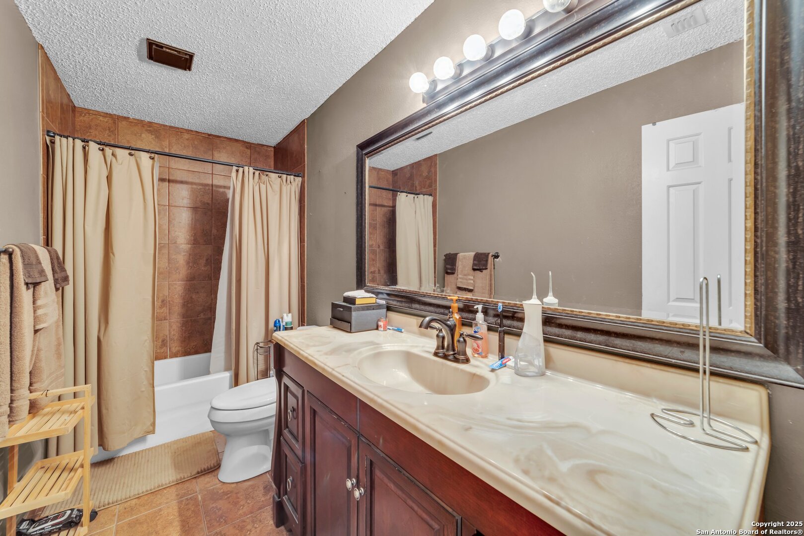 8746 Serene Ridge Drive San Antonio, TX 78239 - Photo 11 of 18 a bathroom with a double vanity sink toilet and a tub