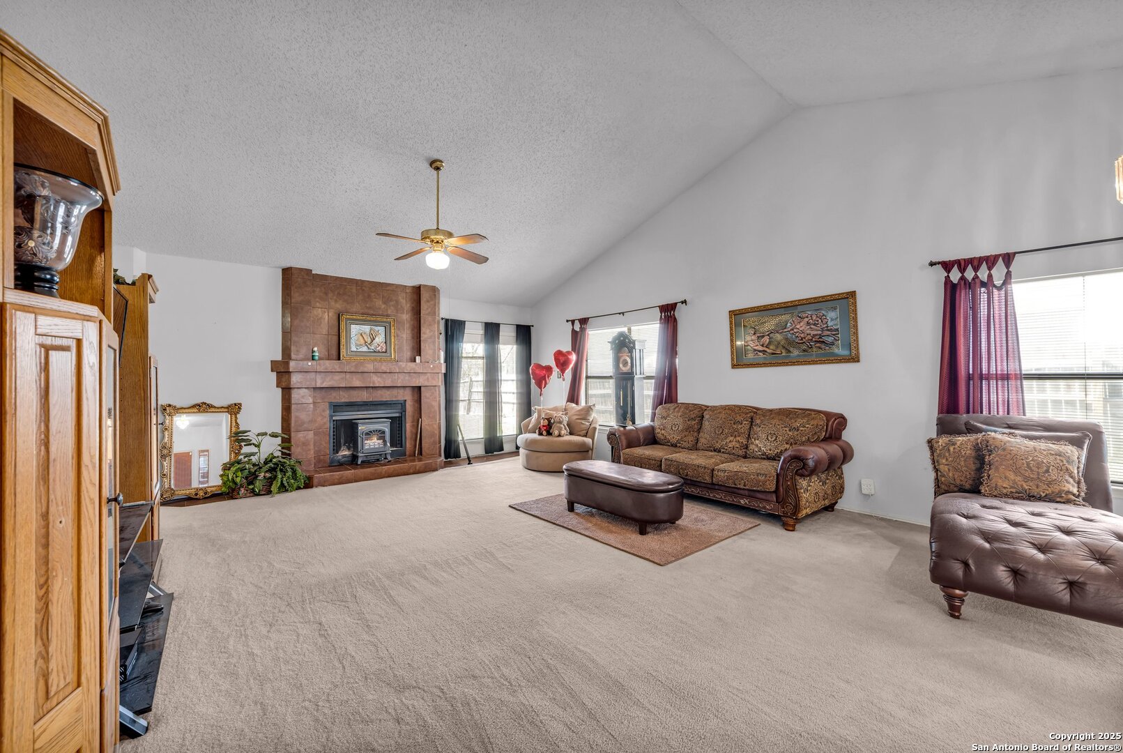 8746 Serene Ridge Drive San Antonio, TX 78239 - Photo 2 of 18 a living room with furniture a fireplace and a flat screen tv
