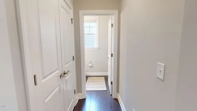 a view of a hallway with wooden floor