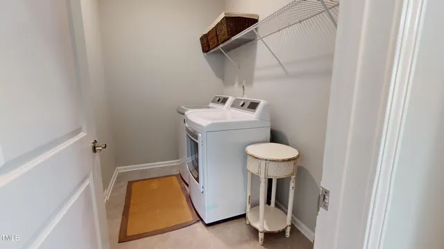 a bed sitting in a spacious bedroom next to a window