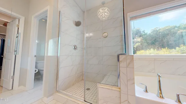 a view of a white house next to a yard