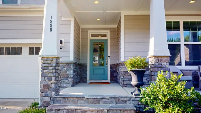 a balcony with furniture and a potted plant