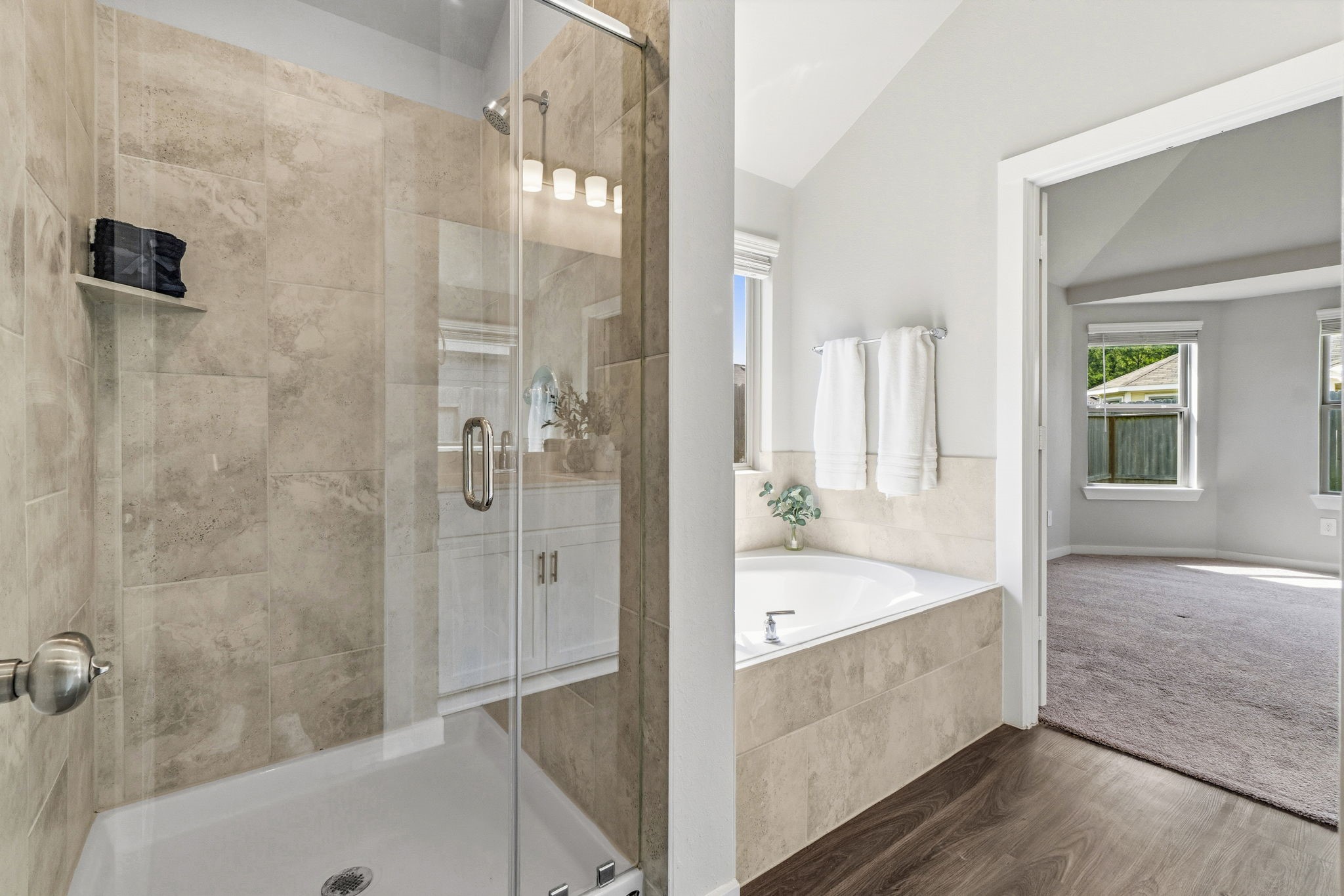 22235 Cardinal Crest Lane New Caney, TX 77357 - Photo 18 of 41 Spacious primary bathroom featuring a relaxing soaking tub, a separate glass-enclosed shower, dual vanities,