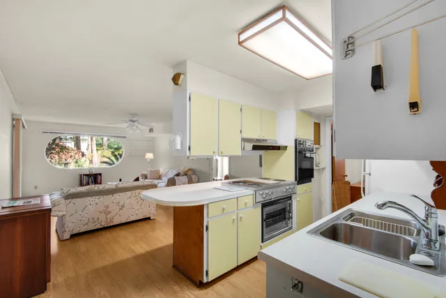 a kitchen that has a sink and a stove in it