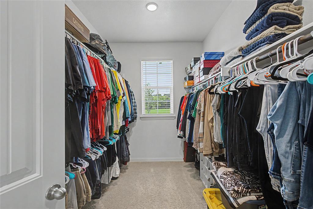 185 Chester Road Springtown, TX 76082 - Photo 26 of 40 Walk-in closet featuring built-in shelving, hanging rods, recessed lighting, a window with blinds, and carpet flooring