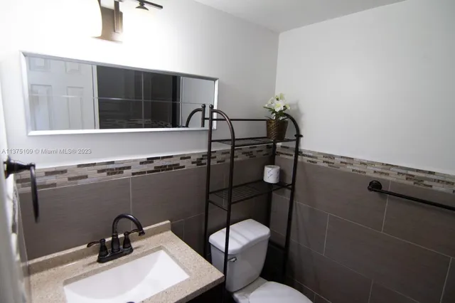 a bathroom with a sink and mirror