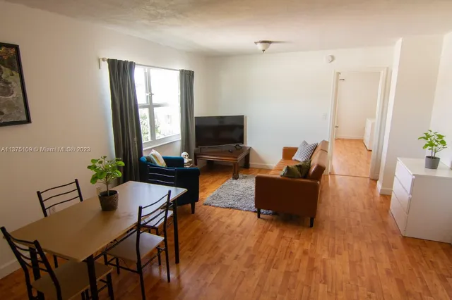 a living room with furniture dining room and wooden floor