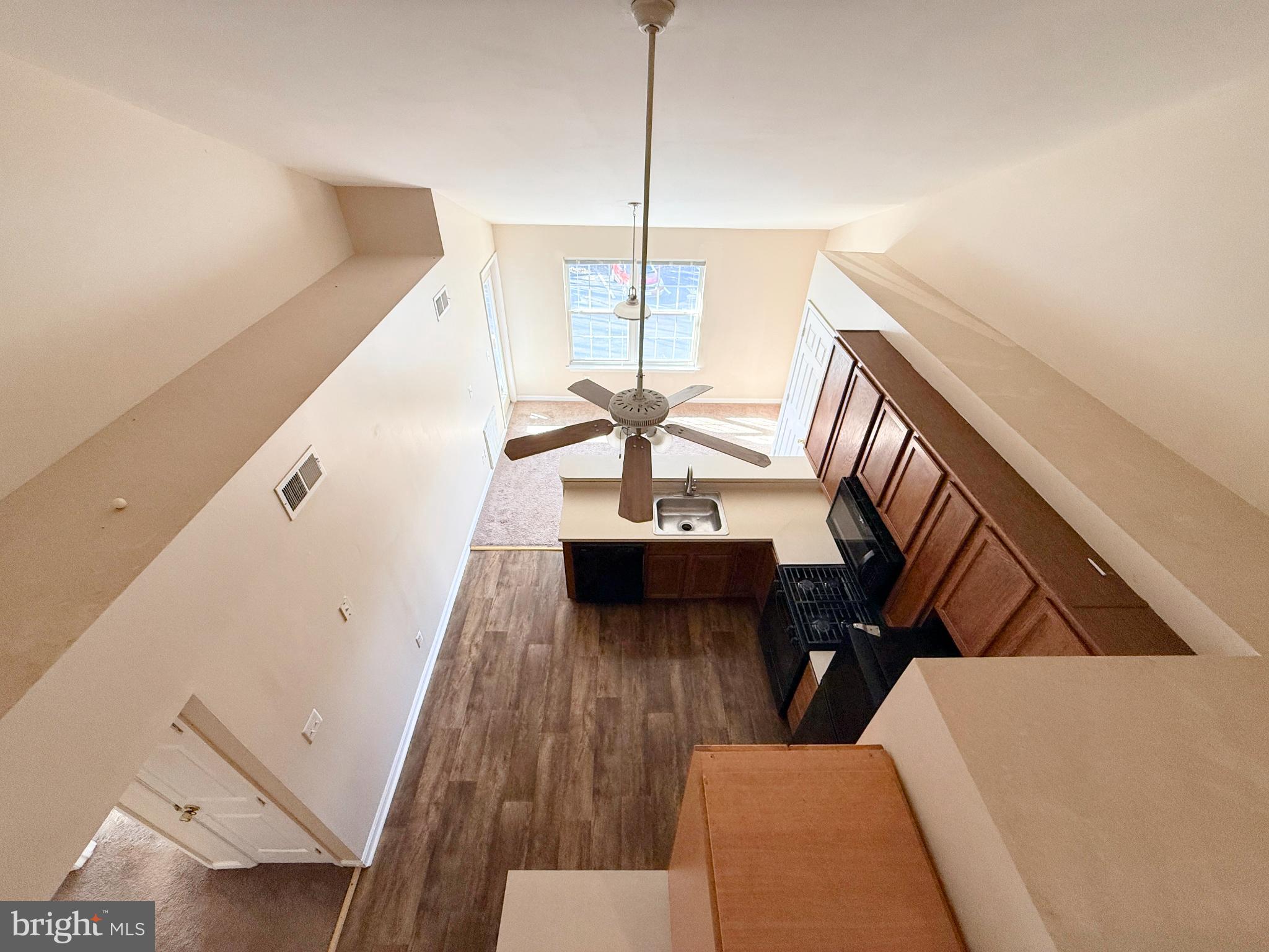 9211 Azure Court, Unit 202 Manassas, VA 20110 - Photo 14 of 16 a living room with furniture and wooden floor