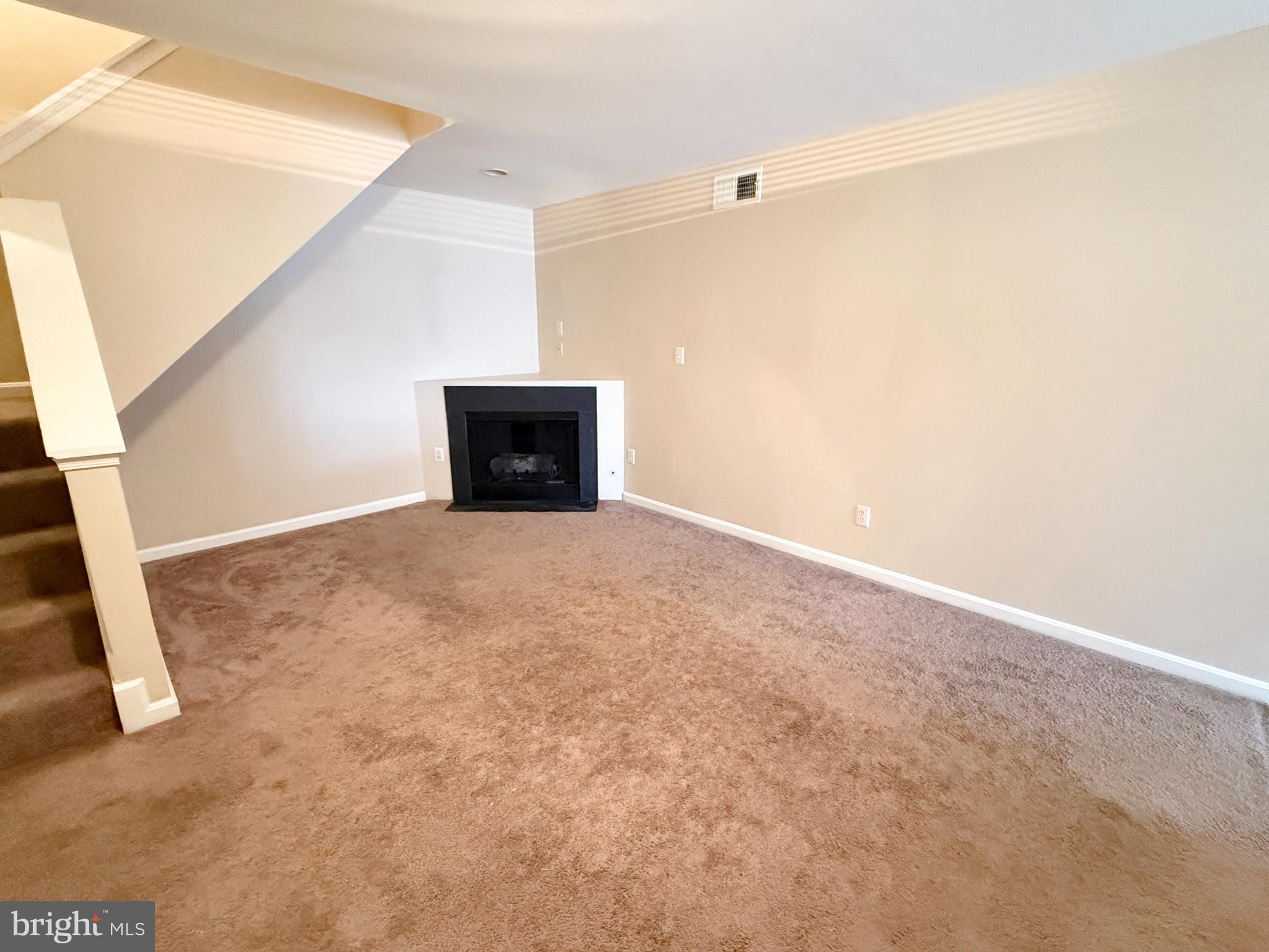 9211 Azure Court, Unit 202 Manassas, VA 20110 - Photo 2 of 16 a view of an empty room with a fireplace