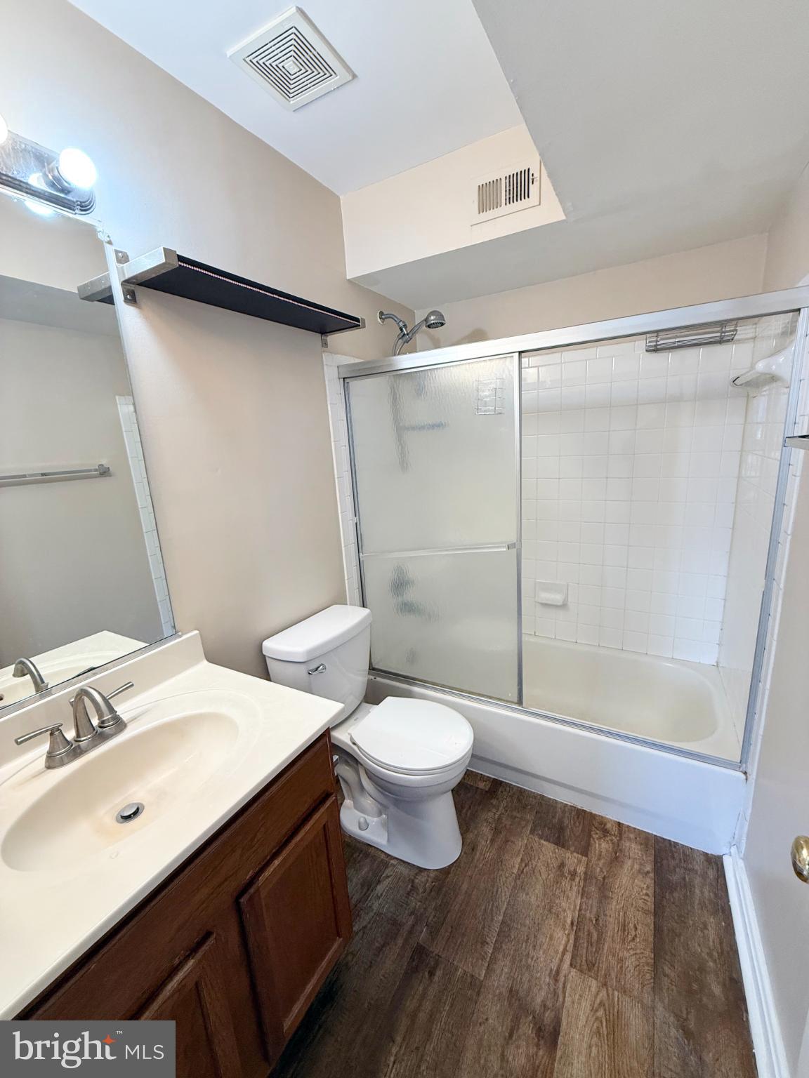 9211 Azure Court, Unit 202 Manassas, VA 20110 - Photo 8 of 16 a bathroom with a sink a toilet a mirror and shower