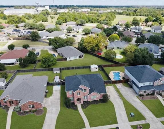 an aerial view of a house with swimming pool and outdoor space