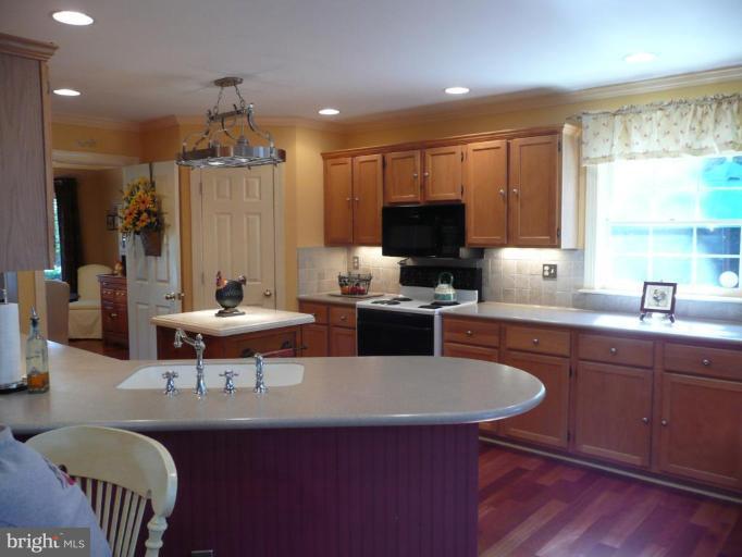 3205 Breckenridge Way Riva, MD 21140 - Photo 5 of 30 a kitchen with a dining table chairs and a refrigerator