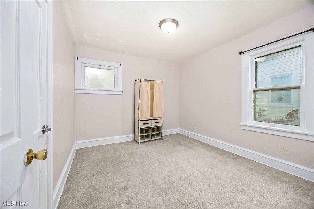 3368 Berea Road Cleveland, OH 44111 - Photo 14 of 26 Unfurnished room with light colored carpet and baseboards
