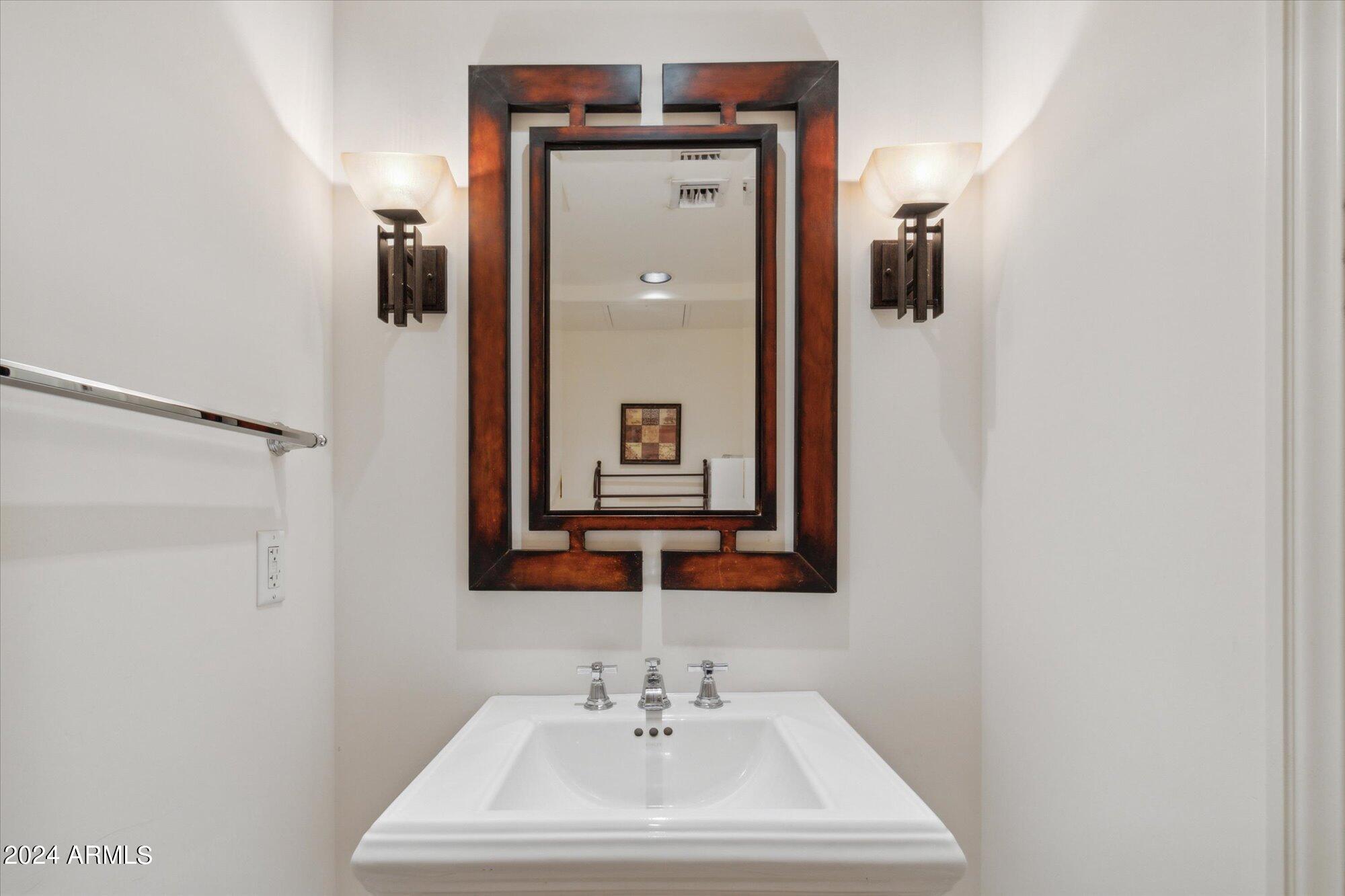 7181 East Camelback Road, Unit 206 Scottsdale, AZ 85251 - Photo 11 of 28 a bathroom with a sink and mirror