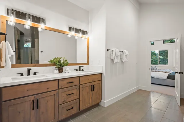 a spacious bathroom with a double vanity sink and mirror