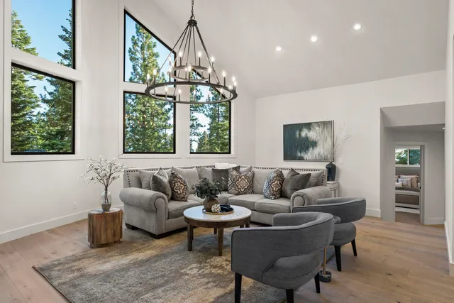 a living room with furniture and a chandelier
