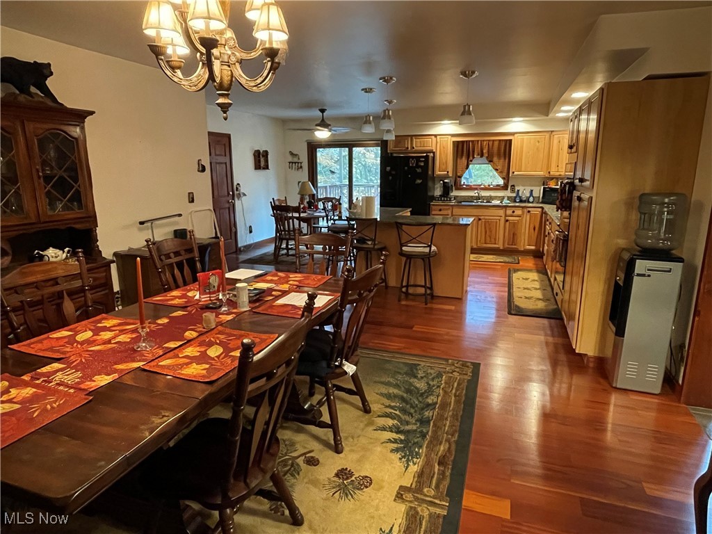 74068 Lake Ridge Road Piedmont, OH 43983 - Photo 14 of 45 Dining room with ceiling fan with notable chandelier, light hardwood / wood-style flooring, and sink