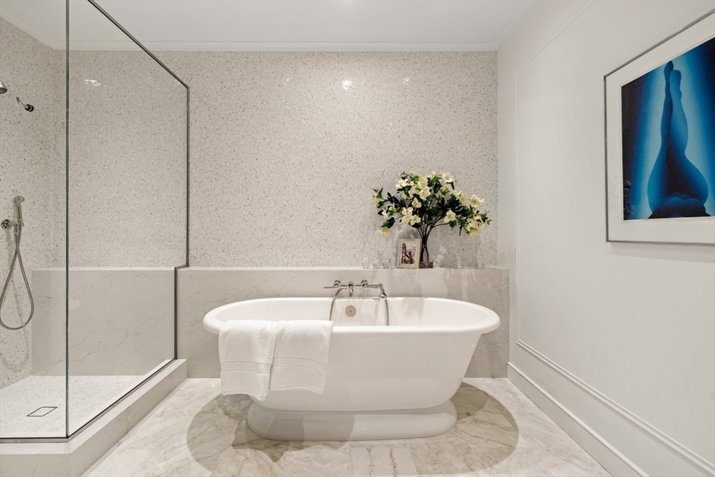 397 Commonwealth Avenue, Unit 2 Boston, MA 02215 - Photo 16 of 23 a white bath tub sitting in a bathroom