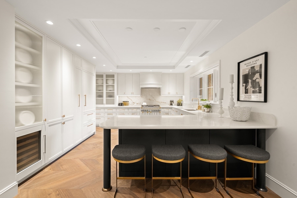 397 Commonwealth Avenue, Unit 2 Boston, MA 02215 - Photo 10 of 23 a kitchen with cabinets table and chairs